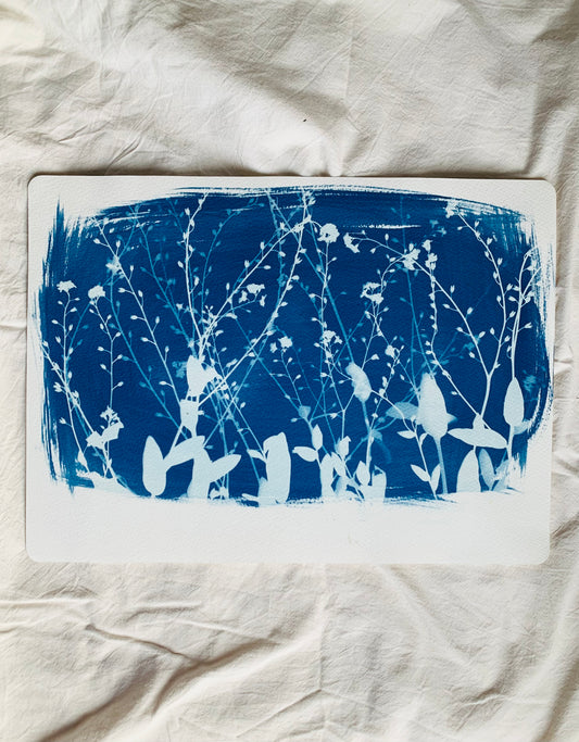 landscape view of layered forget me nots as a cyanotype